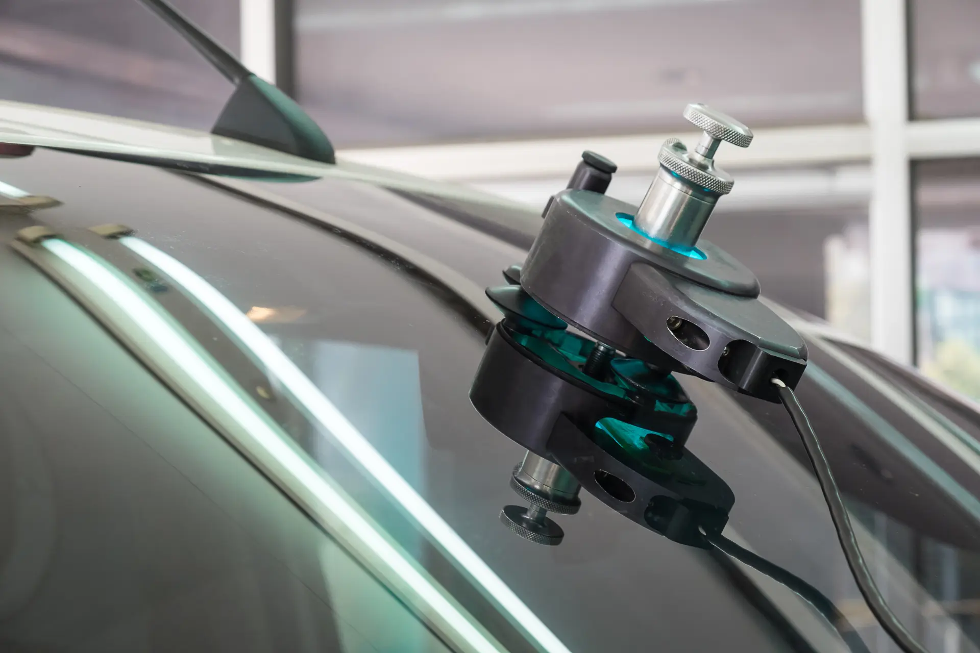 Chip repair injector tool mounted on a windscreen closeup